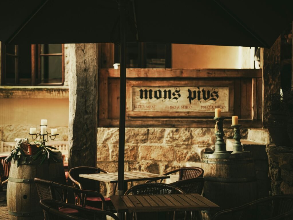 Restaurant exterior at dusk with guests arriving.