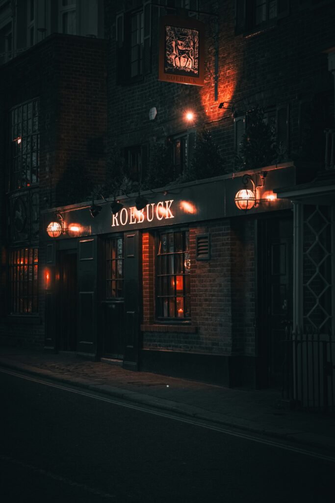 Restaurant exterior lit at night on a city street.